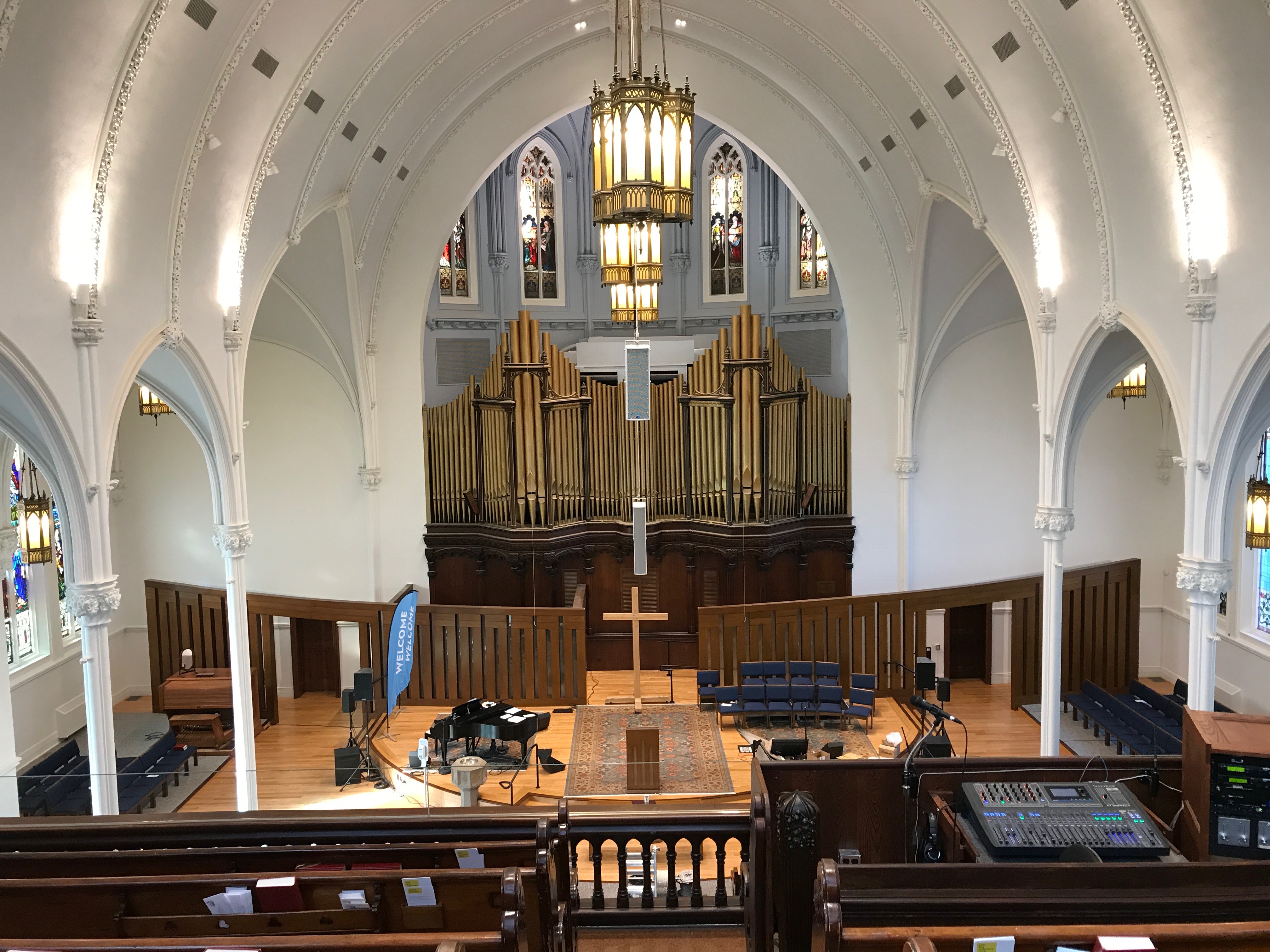 A Danley Sound Labs speaker mounted to a wall in a church sanctuary